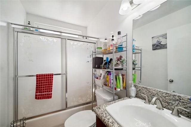 full bathroom featuring vanity, toilet, and bath / shower combo with glass door