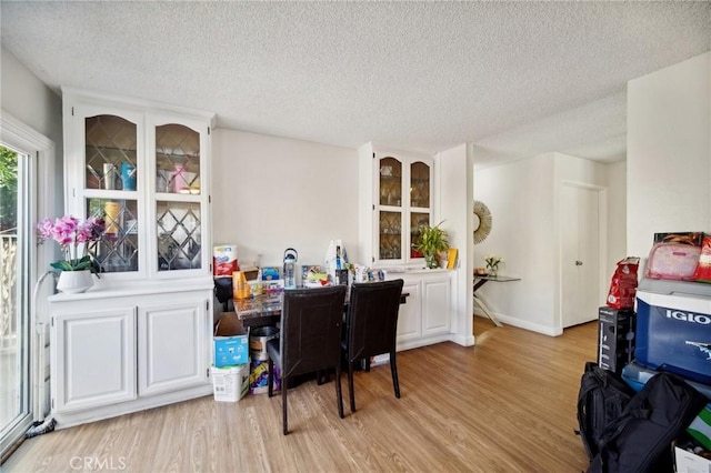 office with a textured ceiling and light hardwood / wood-style floors