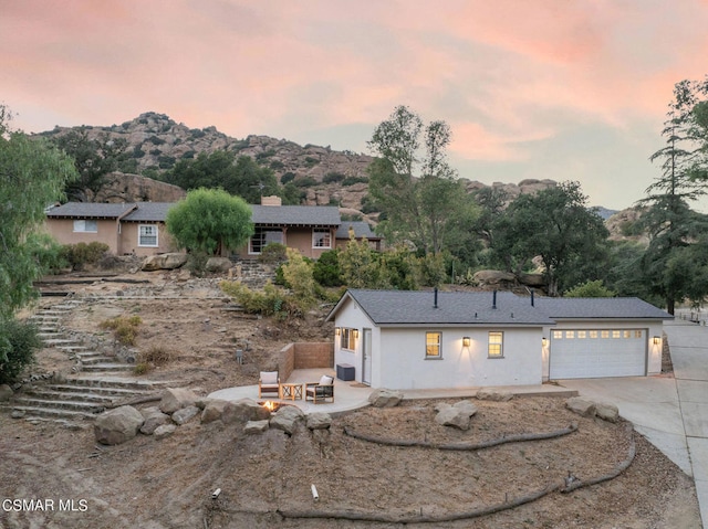 view of front of house with a mountain view and a garage