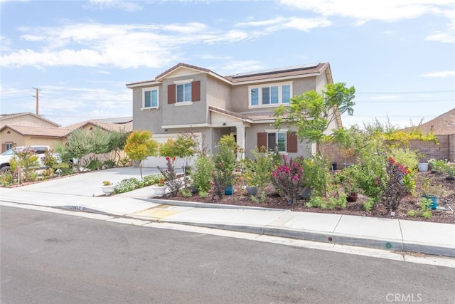 view of front of house with a garage and solar panels