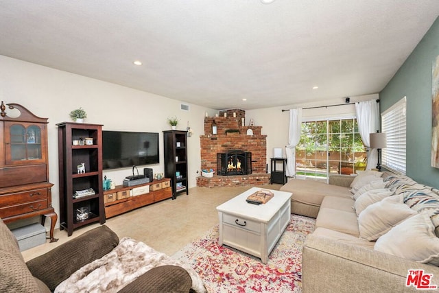 living room with a brick fireplace