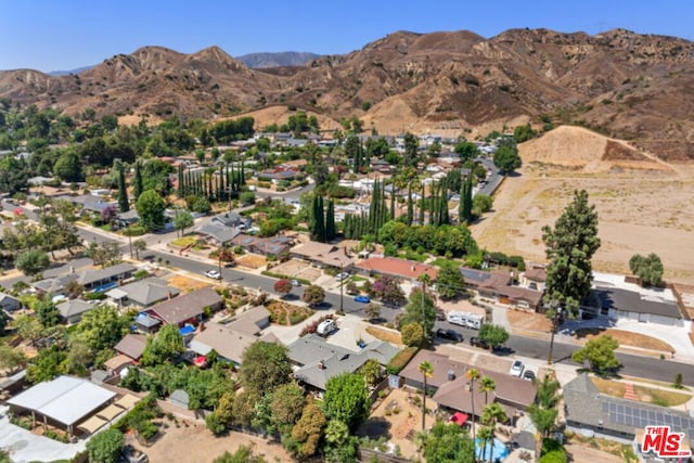 birds eye view of property with a mountain view