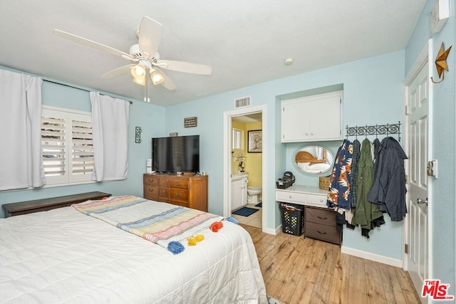 bedroom with light hardwood / wood-style flooring, ensuite bath, and ceiling fan