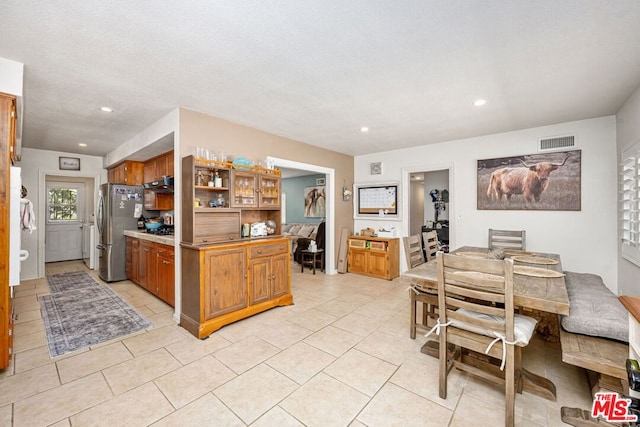 kitchen featuring stainless steel fridge and light tile patterned floors