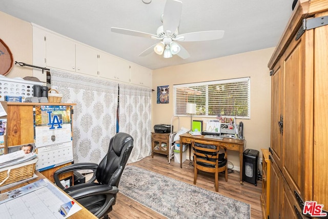 office space featuring ceiling fan and light wood-type flooring