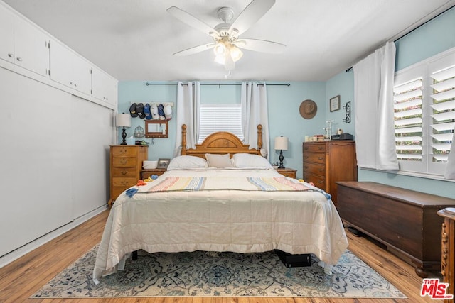 bedroom with ceiling fan and light hardwood / wood-style flooring