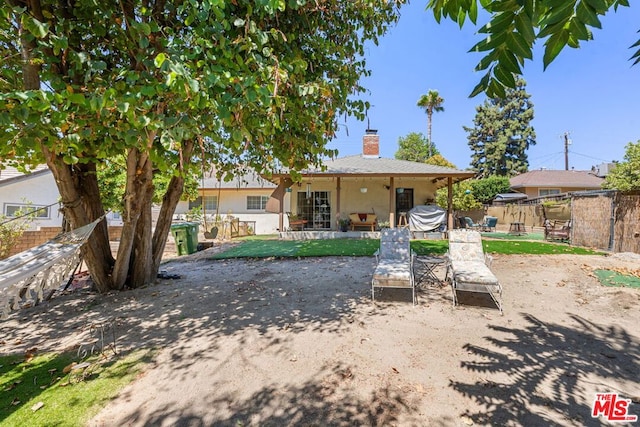 rear view of property featuring a patio area