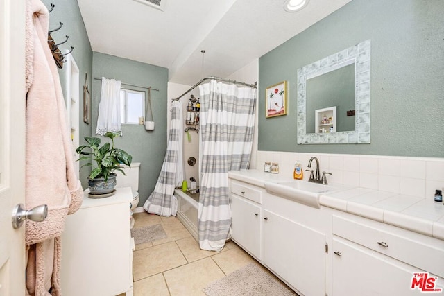 full bathroom with vanity, tasteful backsplash, shower / bath combo, tile patterned floors, and toilet