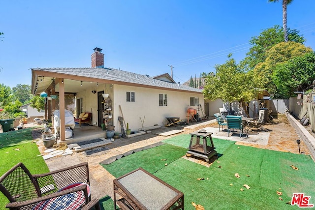 back of house featuring a yard and a patio area