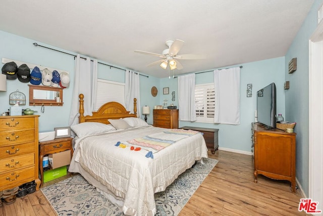 bedroom with ceiling fan and light hardwood / wood-style flooring