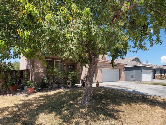 view of property hidden behind natural elements with a front yard and a garage