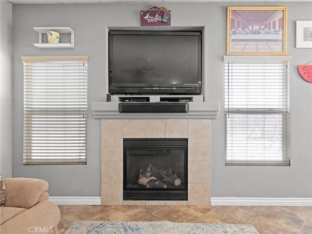 tiled living room with a healthy amount of sunlight and a fireplace