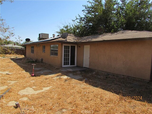 rear view of house featuring central AC unit