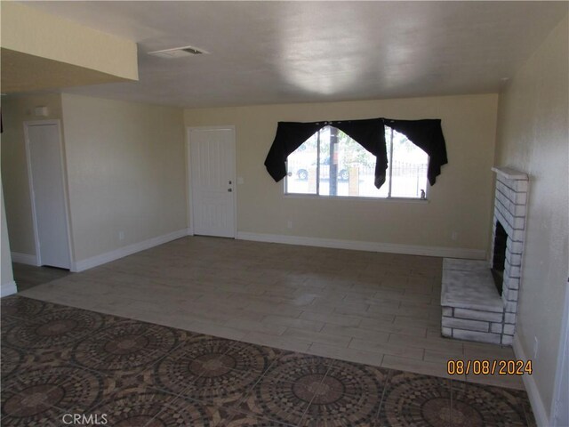 unfurnished living room featuring a fireplace