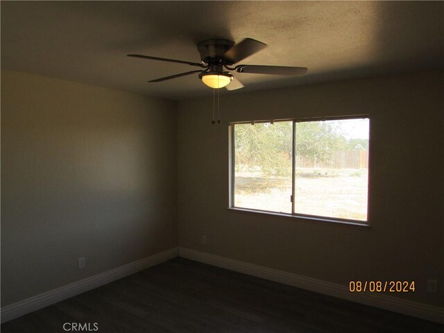 empty room featuring ceiling fan and dark hardwood / wood-style floors