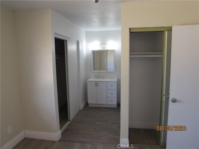 bathroom with vanity and wood-type flooring