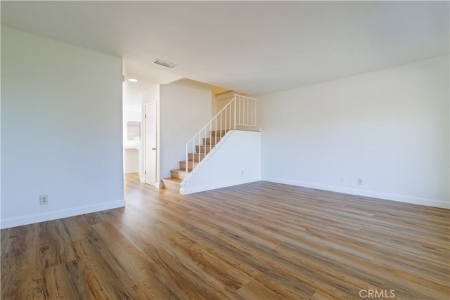 spare room featuring wood-type flooring