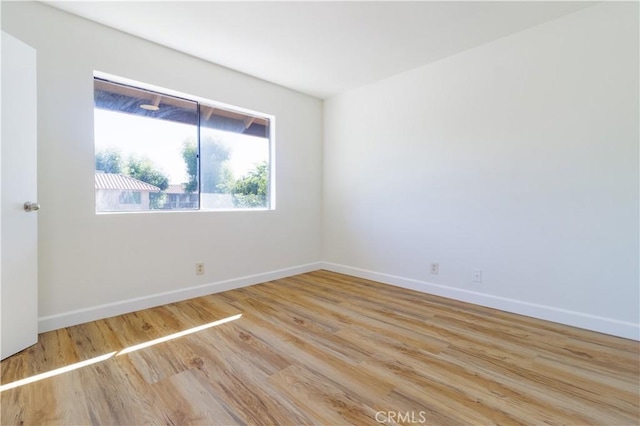 spare room with light hardwood / wood-style floors