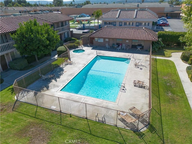 view of swimming pool featuring a patio area and a yard