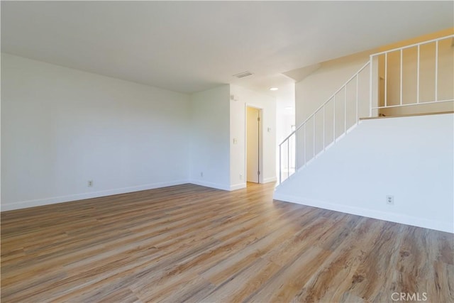 unfurnished living room with light hardwood / wood-style flooring