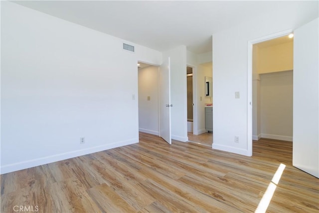 spare room with light wood-type flooring