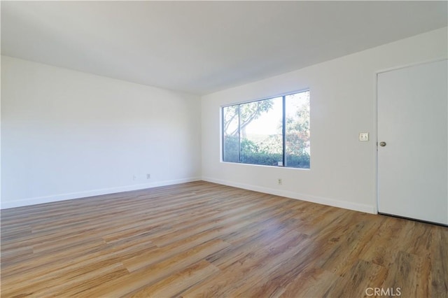 spare room featuring light hardwood / wood-style floors