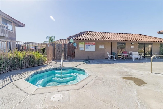 view of pool featuring a community hot tub and a patio