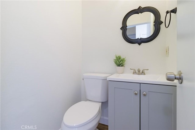 bathroom with toilet and vanity