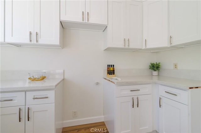 clothes washing area with hardwood / wood-style floors