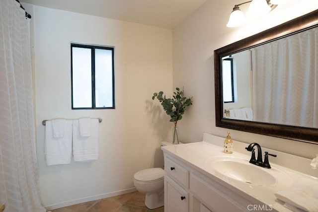 bathroom with vanity, tile patterned floors, and toilet