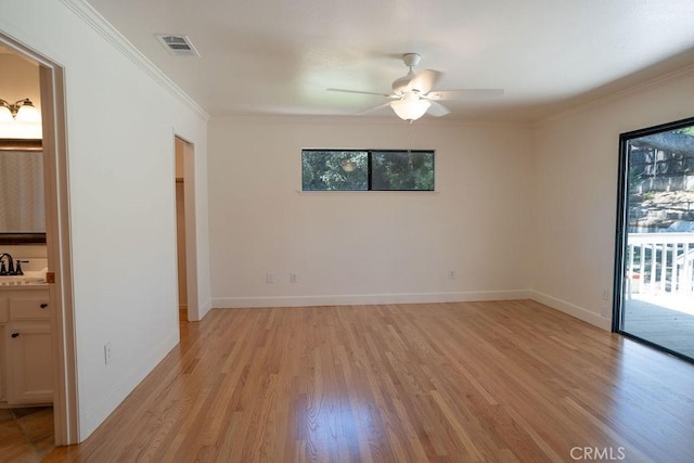 empty room featuring sink, crown molding, light hardwood / wood-style flooring, and ceiling fan