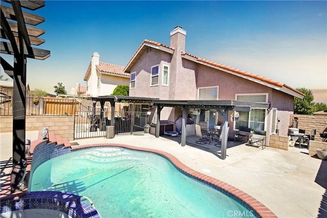 pool at dusk with a patio