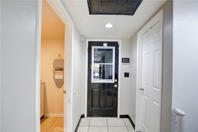 doorway featuring light tile patterned flooring