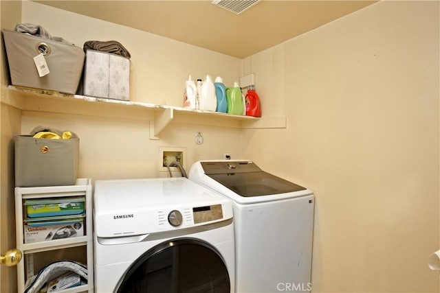 washroom with independent washer and dryer