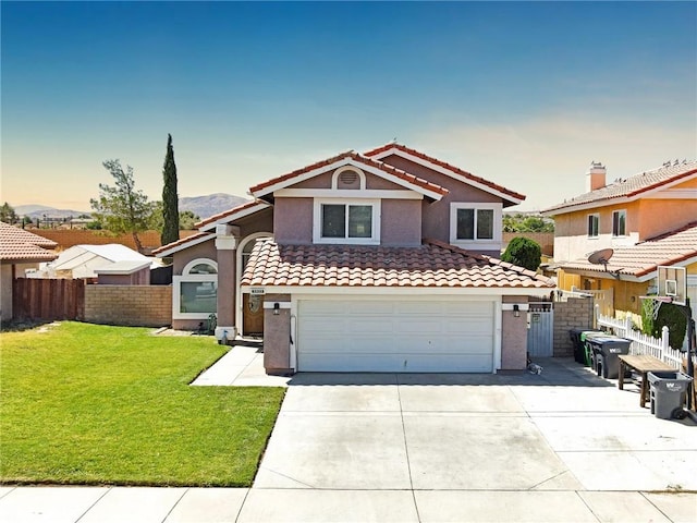 view of front of home with a garage and a lawn