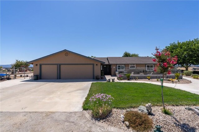 single story home featuring a front yard and a garage