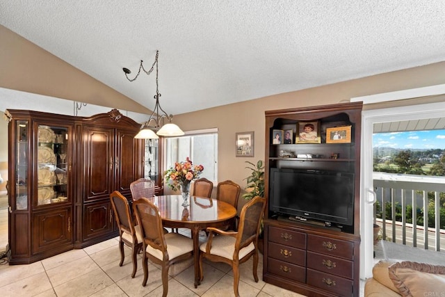 dining space with light tile patterned flooring, vaulted ceiling, and a wealth of natural light