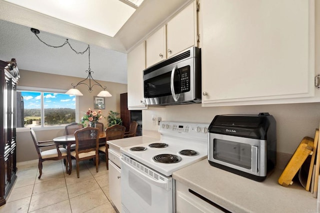 kitchen with white cabinets, light tile patterned flooring, pendant lighting, and white electric stove