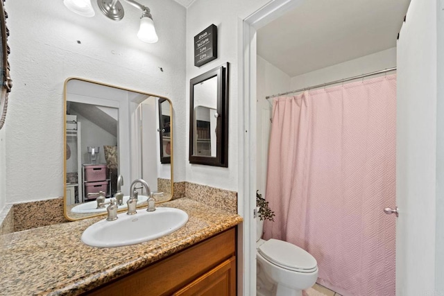 full bathroom featuring shower / bath combo, vanity, and toilet