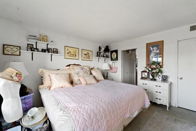 bedroom with carpet and a textured ceiling