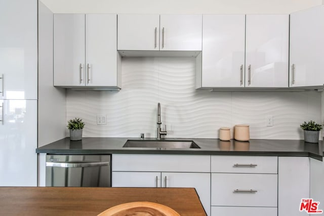 kitchen with white cabinetry, sink, and stainless steel dishwasher