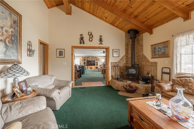 living room featuring lofted ceiling with beams, wood ceiling, carpet floors, and a wood stove