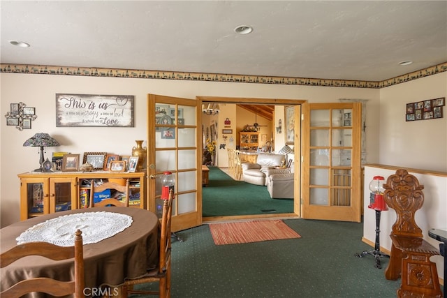 dining room with french doors and dark colored carpet