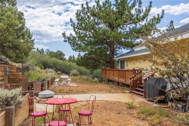 view of yard featuring a patio and a deck