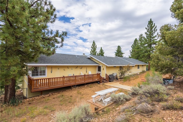 back of property with a wooden deck