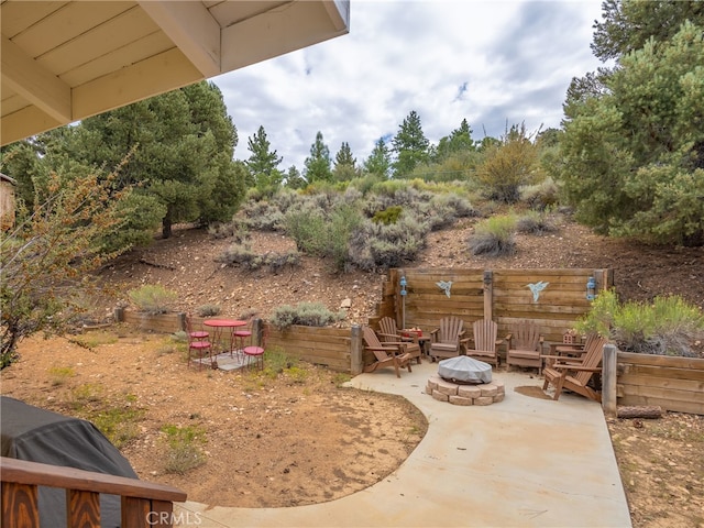 view of yard featuring an outdoor fire pit and a patio area