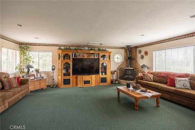 carpeted living room featuring a wood stove