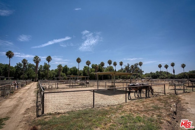 surrounding community with an outbuilding and a rural view