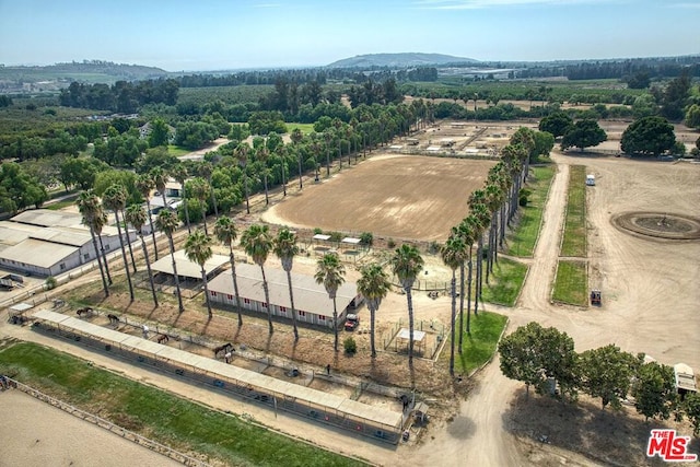 birds eye view of property with a mountain view and a rural view