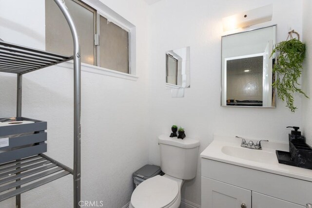 bathroom with toilet and vanity